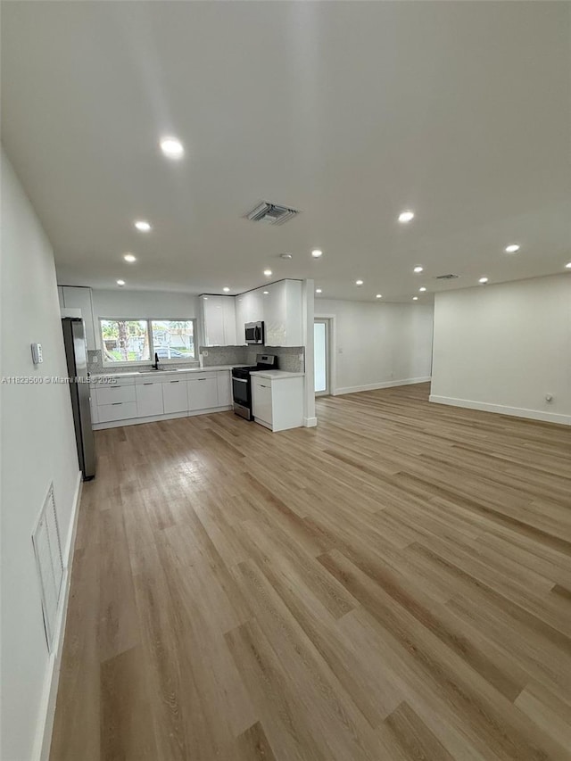 9934 SW 195th St, Cutler Bay, FL 33157 - unfurnished living room featuring recessed lighting and light wood-type flooring