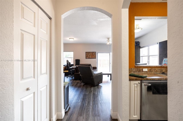 5000 SW 136th Ave, Miramar, FL 33027 - hallway featuring arched walkways, dark wood finished floors, plenty of natural light, and a textured wall