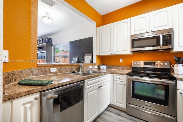 5000 SW 136th Ave, Miramar, FL 33027 - kitchen featuring stainless steel appliances, white cabinets, and light wood-style flooring