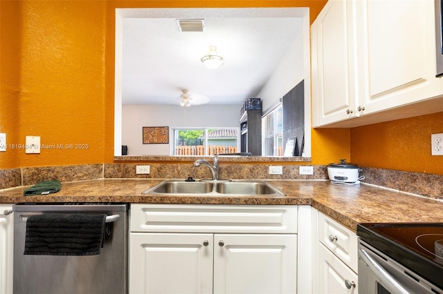 5000 SW 136th Ave, Miramar, FL 33027 - kitchen with dishwasher, white cabinetry, and dark countertops