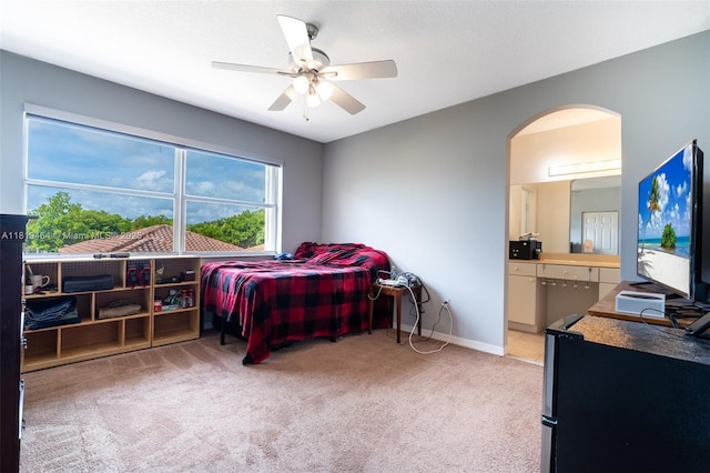 5000 SW 136th Ave, Miramar, FL 33027 - bedroom featuring light colored carpet, arched walkways, ensuite bathroom, and a ceiling fan