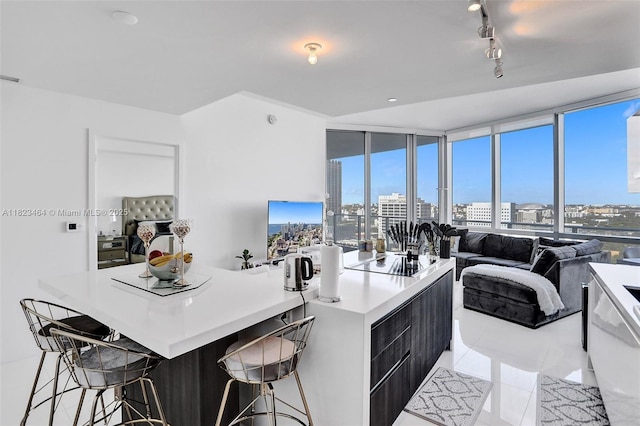 851 NE 1st Ave Unit 2204, Miami, FL 33132 - kitchen with light tile patterned floors, track lighting, a breakfast bar, open floor plan, and light countertops