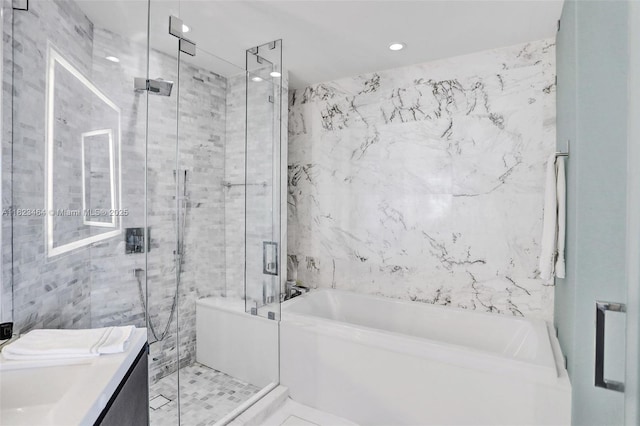 851 NE 1st Ave Unit 2204, Miami, FL 33132 - bathroom featuring a bath, vanity, a shower stall, tile walls, and recessed lighting