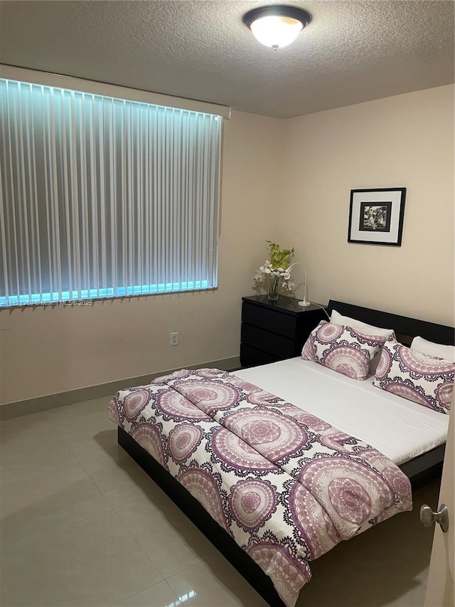 2000 N Bayshore Dr Unit 201, Miami, FL 33137 - tiled bedroom with a textured ceiling