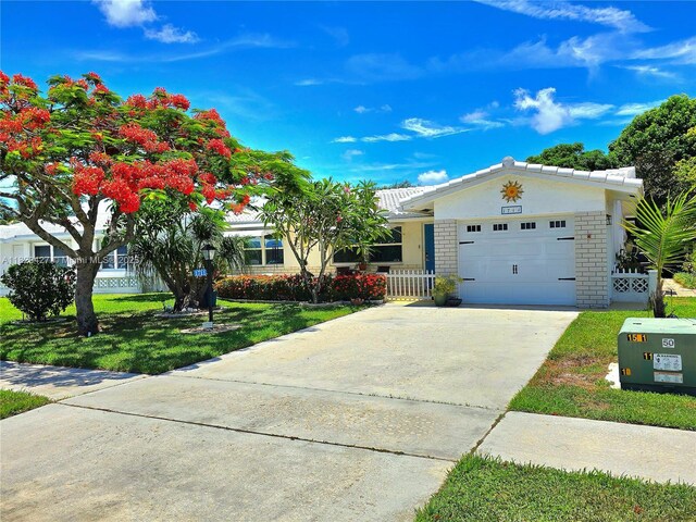1711 SW 22nd St, Boynton Beach, FL 33426 - ranch-style house featuring an attached garage, concrete driveway, and a tiled roof