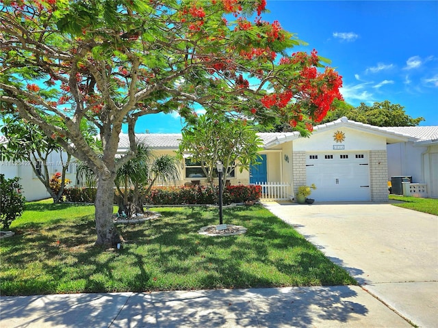1711 SW 22nd St, Boynton Beach, FL 33426 - view of front of property featuring a garage, a front lawn, and driveway