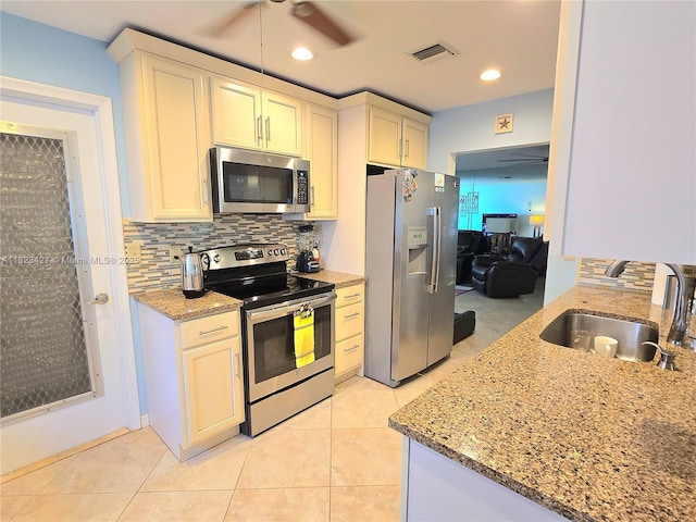 1711 SW 22nd St, Boynton Beach, FL 33426 - kitchen featuring stainless steel appliances, backsplash, light stone counters, ceiling fan, and recessed lighting