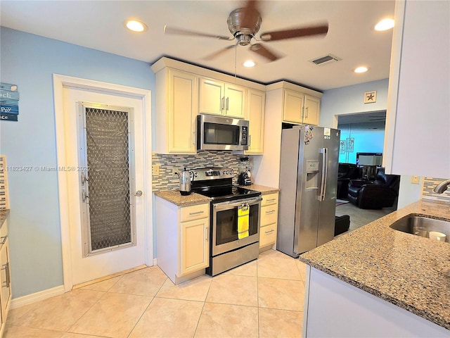 1711 SW 22nd St, Boynton Beach, FL 33426 - kitchen with stainless steel appliances, a ceiling fan, decorative backsplash, light stone counters, and recessed lighting