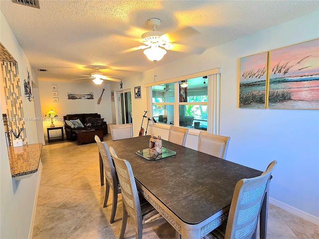 1711 SW 22nd St, Boynton Beach, FL 33426 - dining area with a textured ceiling, ceiling fan, and light tile patterned flooring