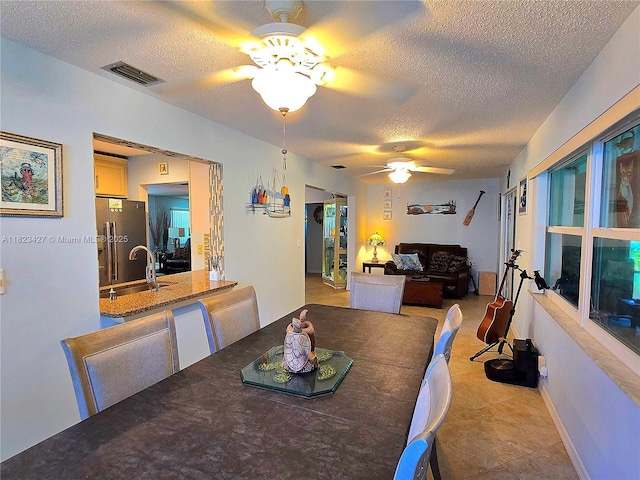 1711 SW 22nd St, Boynton Beach, FL 33426 - dining room featuring ceiling fan, a textured ceiling, and light tile patterned flooring