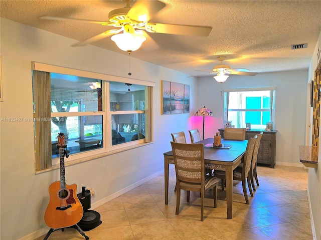 1711 SW 22nd St, Boynton Beach, FL 33426 - dining room featuring a textured ceiling, a ceiling fan, and light tile patterned flooring