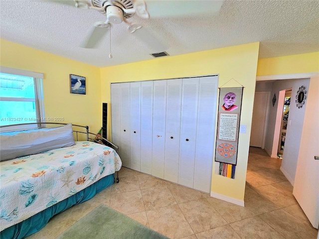 1711 SW 22nd St, Boynton Beach, FL 33426 - bedroom featuring a closet, a textured ceiling, tile patterned floors, and a ceiling fan