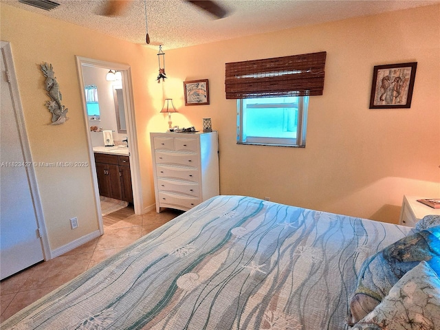 1711 SW 22nd St, Boynton Beach, FL 33426 - bedroom featuring light tile patterned floors, a textured ceiling, and ensuite bath