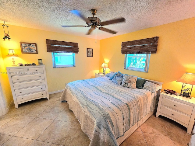 1711 SW 22nd St, Boynton Beach, FL 33426 - bedroom with light tile patterned floors, a textured ceiling, and ceiling fan