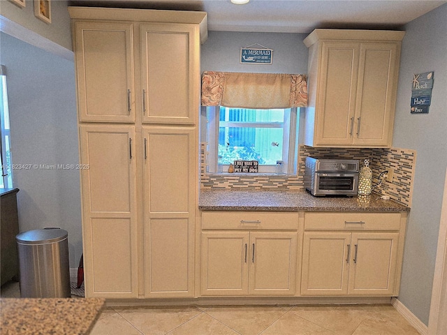 1711 SW 22nd St, Boynton Beach, FL 33426 - kitchen with tasteful backsplash, light tile patterned flooring, and stone counters