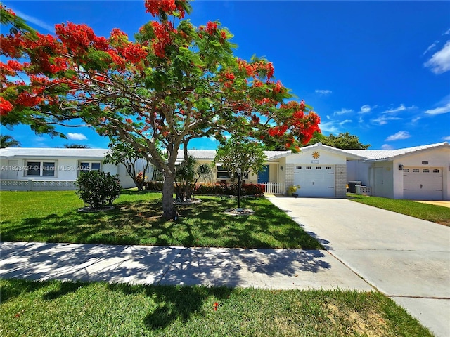 1711 SW 22nd St, Boynton Beach, FL 33426 - ranch-style house with a garage, a front lawn, and concrete driveway