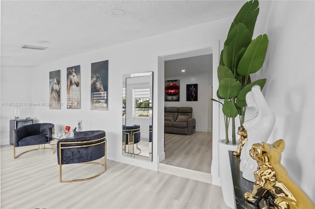 6474 Palm Ave, Hialeah, FL 33012 - sitting room with wood finished floors and a textured ceiling
