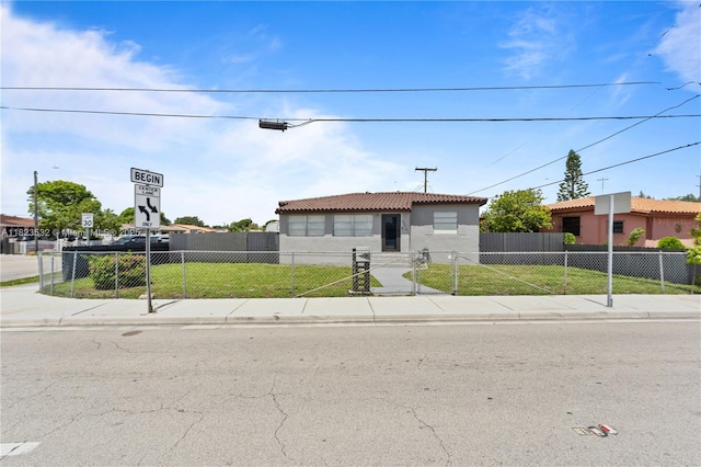 6474 Palm Ave, Hialeah, FL 33012 - view of front of property featuring a tiled roof, a fenced front yard, and stucco siding