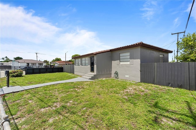 6474 Palm Ave, Hialeah, FL 33012 - back of property featuring entry steps, stucco siding, and a tiled roof