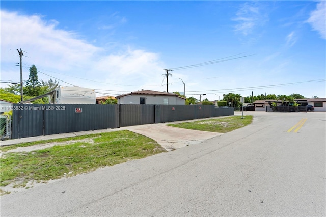6474 Palm Ave, Hialeah, FL 33012 - view of asphalt road with a gate and street lighting