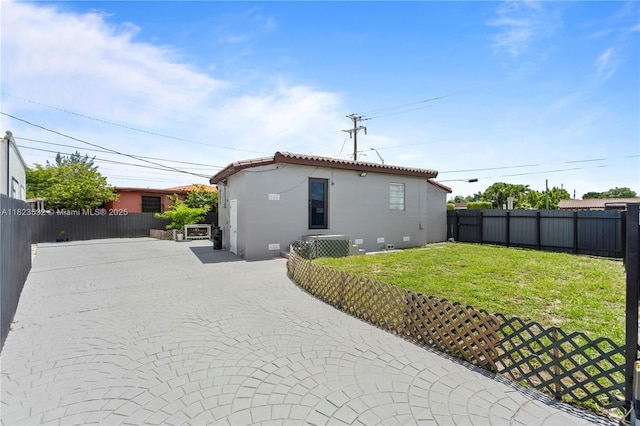 6474 Palm Ave, Hialeah, FL 33012 - rear view of house with stucco siding and a tiled roof