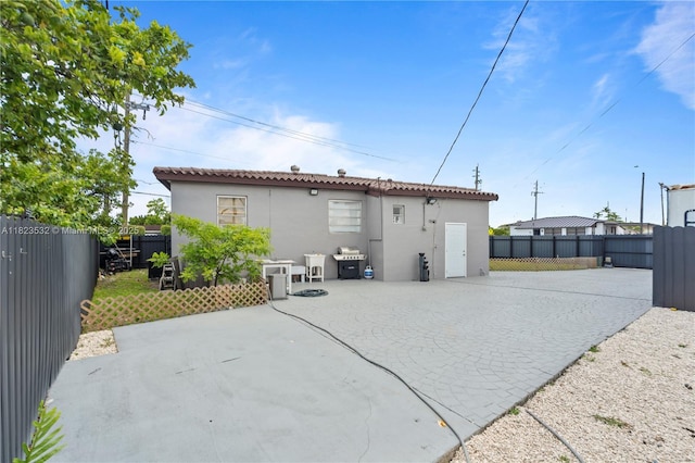 6474 Palm Ave, Hialeah, FL 33012 - rear view of property with stucco siding, a patio, a fenced backyard, and driveway
