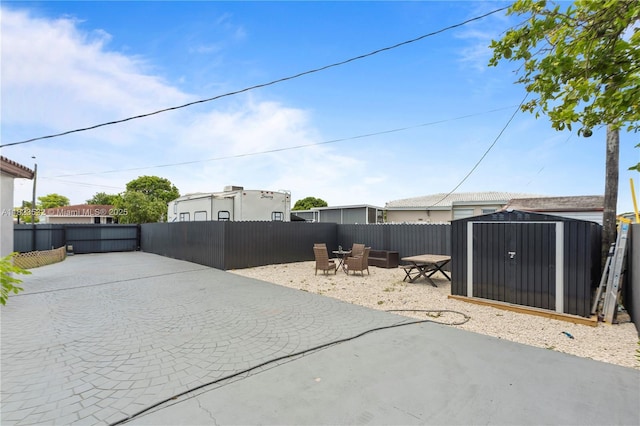 6474 Palm Ave, Hialeah, FL 33012 - fenced backyard with a patio, driveway, and a storage shed