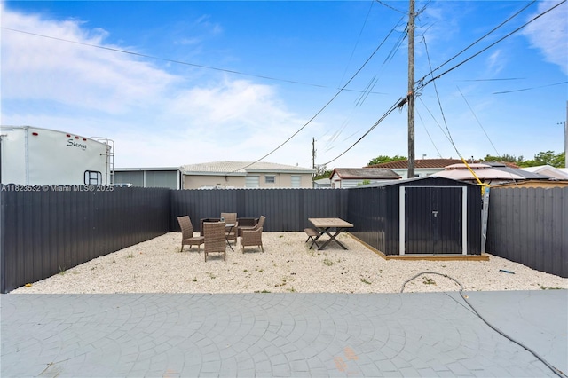 6474 Palm Ave, Hialeah, FL 33012 - fenced backyard featuring a shed, a patio area, and outdoor dining space