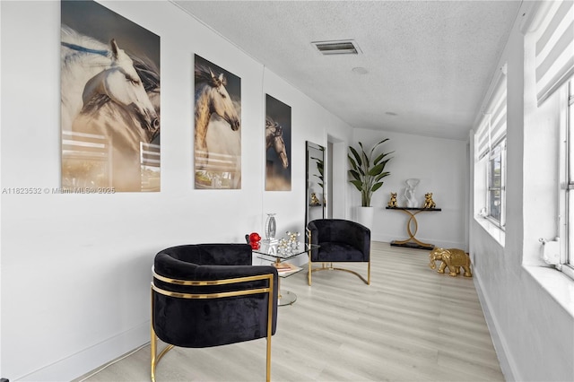 6474 Palm Ave, Hialeah, FL 33012 - sitting room with a textured ceiling and wood finished floors