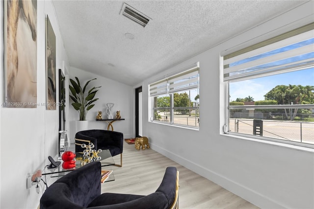 6474 Palm Ave, Hialeah, FL 33012 - living area featuring a textured ceiling, wood finished floors, and lofted ceiling