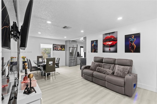 6474 Palm Ave, Hialeah, FL 33012 - living area with light wood-style flooring, recessed lighting, and a textured ceiling
