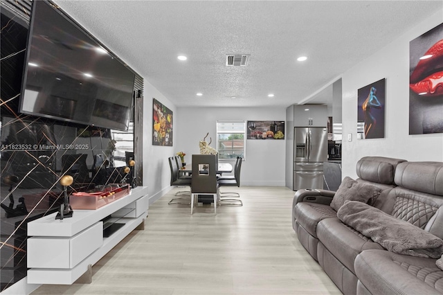 6474 Palm Ave, Hialeah, FL 33012 - living area featuring light wood-style floors, a textured ceiling, and recessed lighting