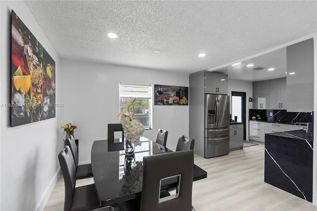 6474 Palm Ave, Hialeah, FL 33012 - dining room with a textured ceiling, recessed lighting, and light wood-type flooring