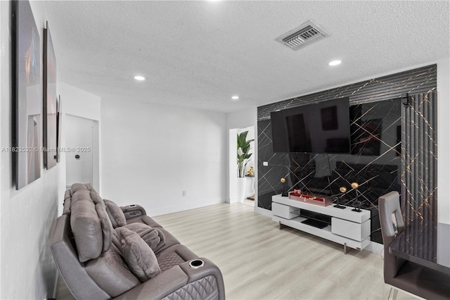 6474 Palm Ave, Hialeah, FL 33012 - living room featuring recessed lighting, a textured ceiling, and light wood-style flooring