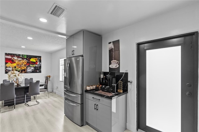 6474 Palm Ave, Hialeah, FL 33012 - kitchen featuring freestanding refrigerator, dark countertops, gray cabinets, recessed lighting, and light wood-style flooring