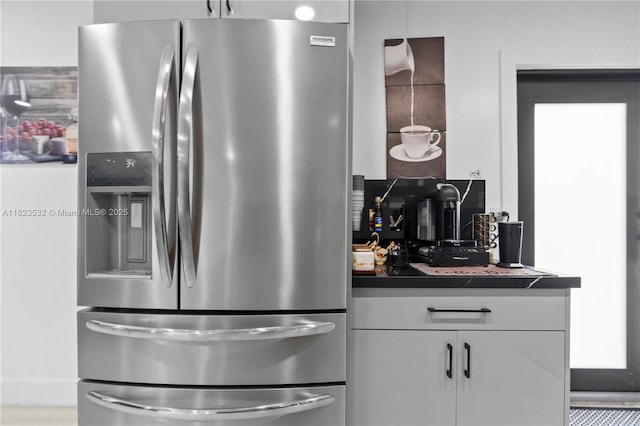 6474 Palm Ave, Hialeah, FL 33012 - kitchen featuring stainless steel refrigerator with ice dispenser, dark countertops, and white cabinets