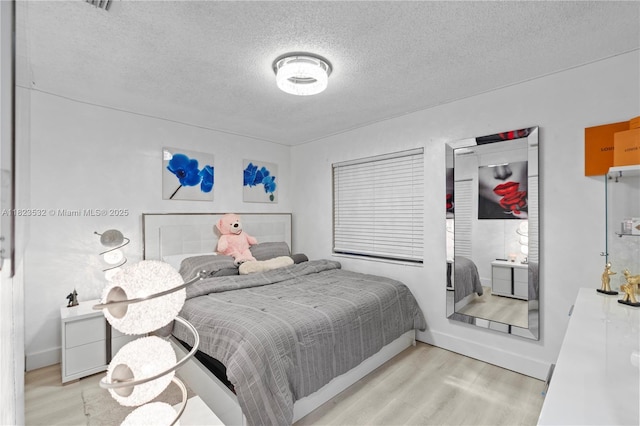 6474 Palm Ave, Hialeah, FL 33012 - bedroom with wood finished floors and a textured ceiling