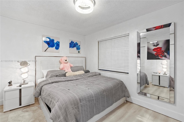 6474 Palm Ave, Hialeah, FL 33012 - bedroom featuring wood finished floors and a textured ceiling