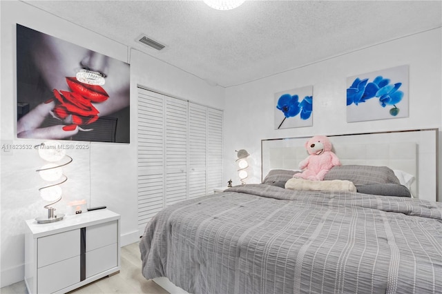6474 Palm Ave, Hialeah, FL 33012 - bedroom featuring a textured ceiling and light wood-type flooring