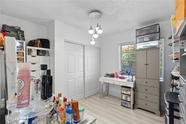 6474 Palm Ave, Hialeah, FL 33012 - recreation room with light wood-style flooring, a textured ceiling, and a chandelier