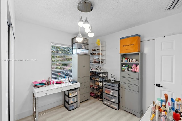 6474 Palm Ave, Hialeah, FL 33012 - home office featuring light wood-type flooring and a textured ceiling