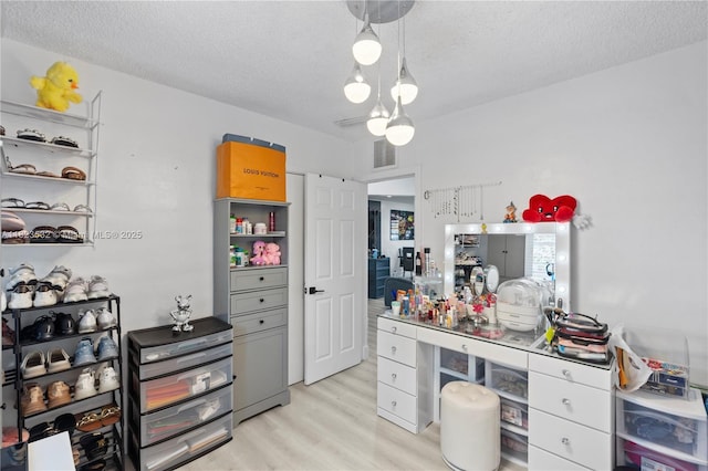 6474 Palm Ave, Hialeah, FL 33012 - home office with light wood-style floors and a textured ceiling