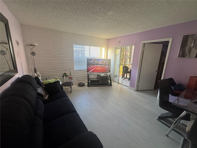 6515 W 27th Ct Unit 49-13, Hialeah, FL 33016 - living area featuring a textured ceiling and wood finished floors