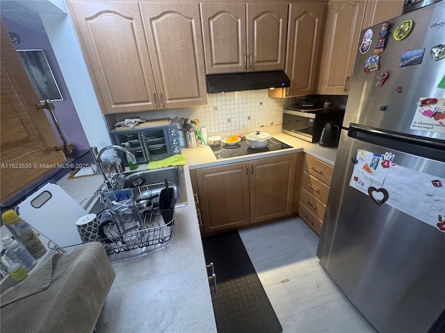 6515 W 27th Ct Unit 49-13, Hialeah, FL 33016 - kitchen featuring stainless steel appliances, under cabinet range hood, light countertops, and light flooring