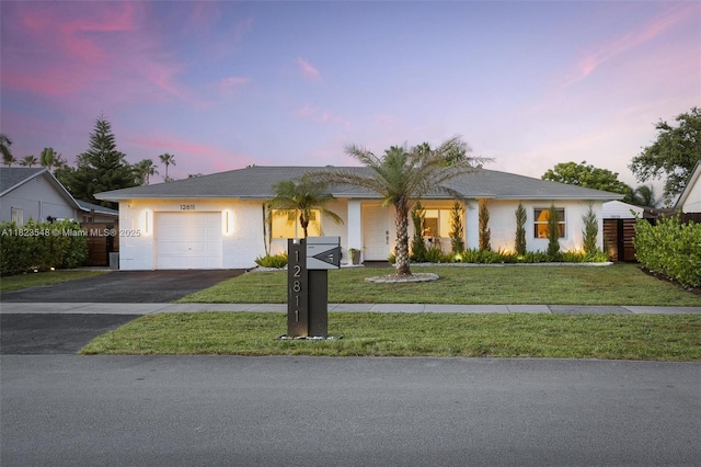 12811 SW 9th Pl, Davie, FL 33325 - ranch-style house with a garage, driveway, stucco siding, and a front yard