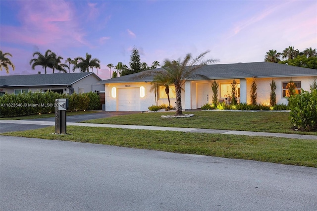 12811 SW 9th Pl, Davie, FL 33325 - ranch-style house featuring driveway, an attached garage, stucco siding, and a front lawn