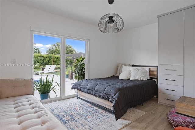 12811 SW 9th Pl, Davie, FL 33325 - bedroom with access to exterior, wood finished floors, and a chandelier