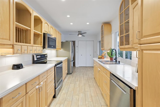 12811 SW 9th Pl, Davie, FL 33325 - kitchen featuring stainless steel appliances, backsplash, light brown cabinetry, light countertops, and glass insert cabinets