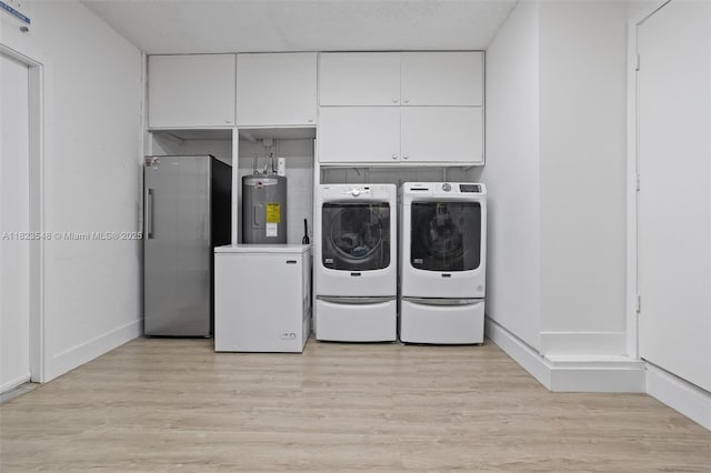 12811 SW 9th Pl, Davie, FL 33325 - laundry room with washer and dryer, water heater, light wood-style floors, and cabinet space