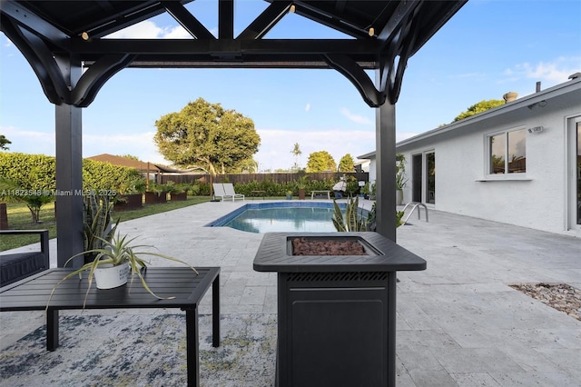 12811 SW 9th Pl, Davie, FL 33325 - view of swimming pool featuring a fire pit, a fenced backyard, a gazebo, and a patio area